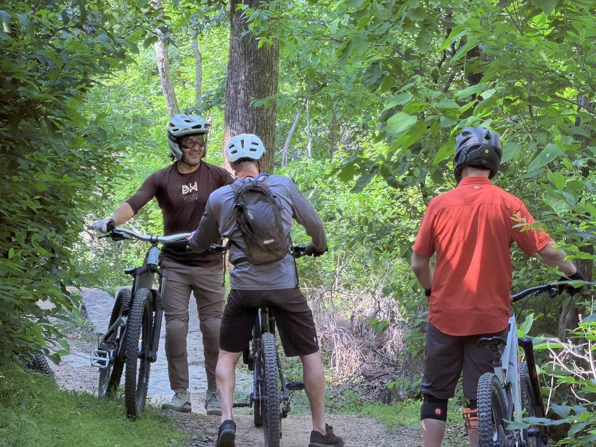 Guided group pausing on a Bentonville singletrack